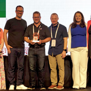 Josh Riedey and Jason Trainer accept an award on stage